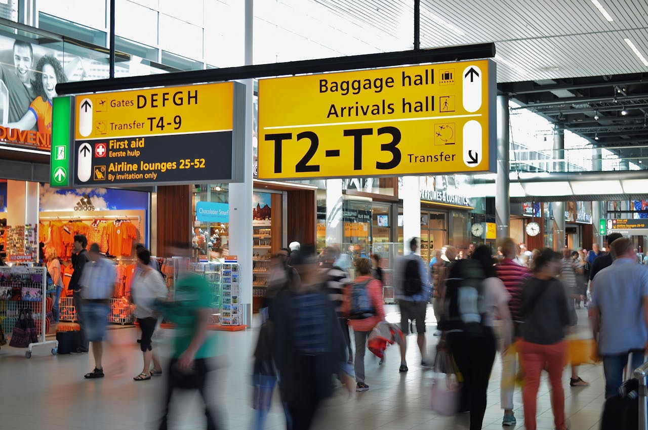 Crafting Captivating Headlines: Your awesome post title goes here Crowded airport with motion blur and clear signage indicating baggage and arrival halls.