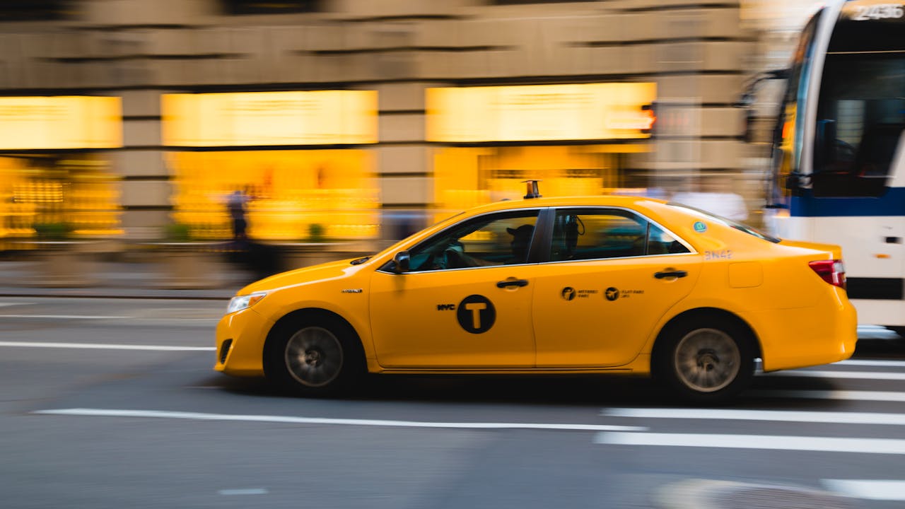 The Art of Drawing Readers In: Your attractive post title goes here A New York City yellow taxi speeds through urban streets, capturing the bustle of city life.